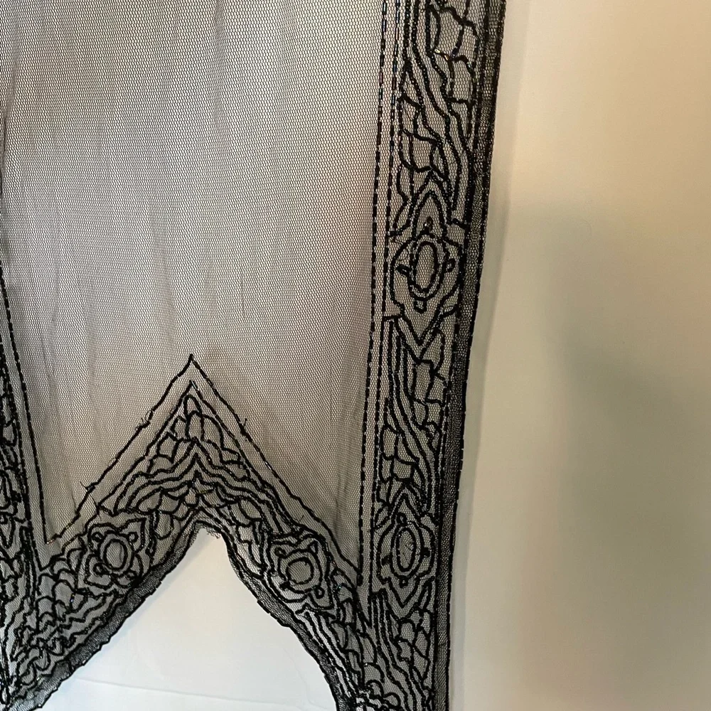Black see through shawl with rainbow beaded accent around.​​​​​​​​​​​​​